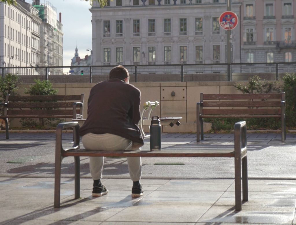 Man sitting alone on bench